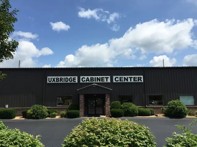 Uxbridge Cabinet Center shop building on Quaker Hwy, a dark metal building with a large white sign